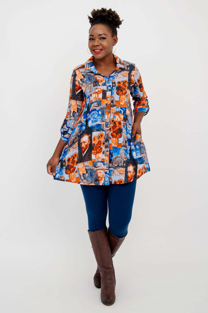 Woman holding out sides of flowing Van Gogh print tunic, smiling