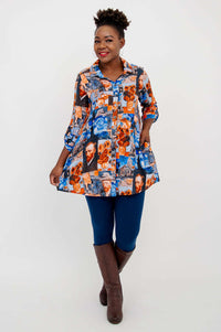 Woman holding out sides of flowing Van Gogh print tunic, smiling