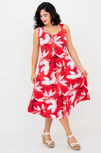 Model playfully holding skirt of red floral A-line tank dress