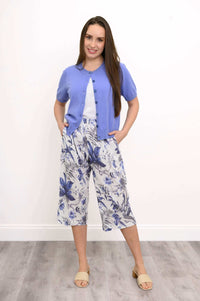 Model wearing blue floral Bella Capri Pant with purple short-sleeve cardigan