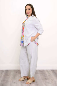 Model in Boardwalk Crop Pants and white shirt, side view with floral blouse
