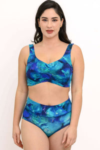 Model wearing the Clipper Top in Ocean Marble print, showing front view of crop top and high-waisted bottoms