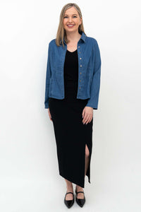 Woman wearing Eva slim black skirt and blue button-up shirt, front view