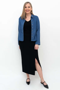 Woman wearing Eva slim black skirt and blue shirt, side stance
