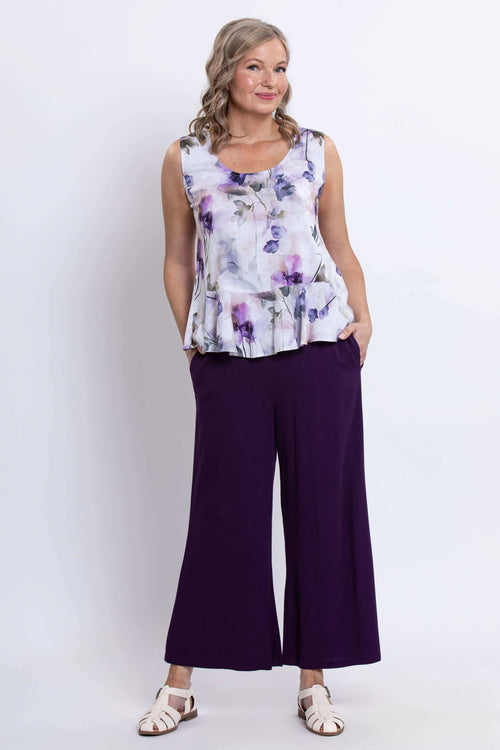Model in Ginny Tank with purple floral pattern paired with wide-leg purple pants