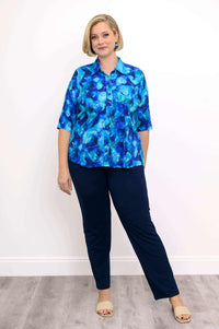 Model posing in Lorine blue bamboo-linen blouse with navy pants and sandals