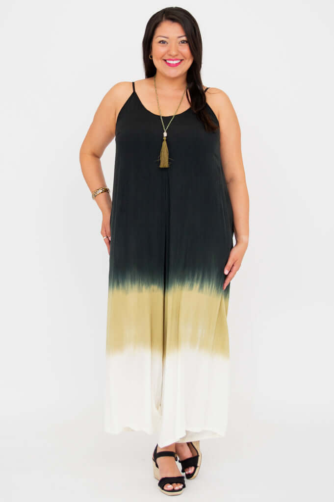 Front-facing image of a woman modeling an ombre jumpsuit with pockets and a relaxed fit