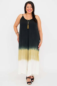 Front-facing image of a woman modeling an ombre jumpsuit with pockets and a relaxed fit