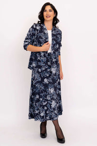 Model in coordinated navy floral skirt and open jacket set