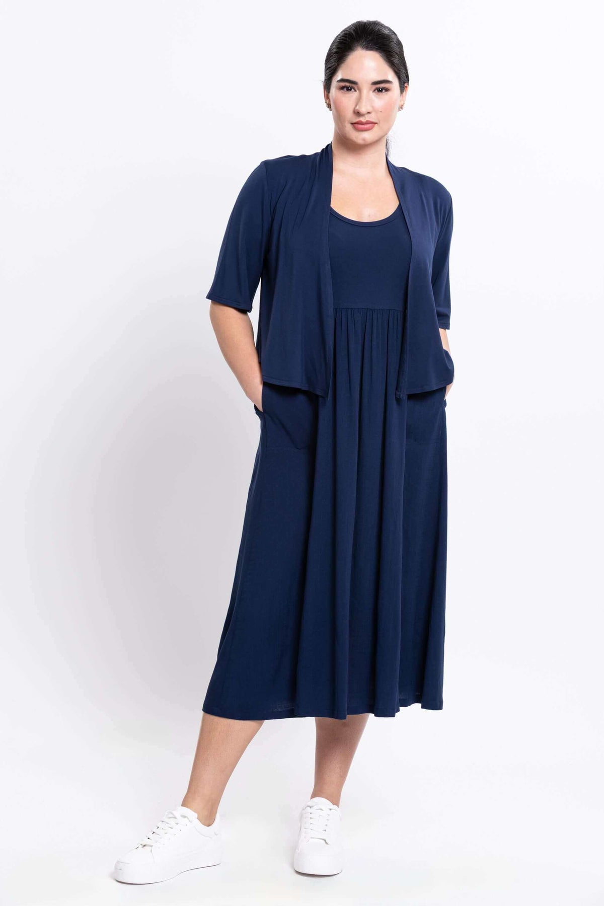 Model in indigo midi dress paired with matching open cardigan