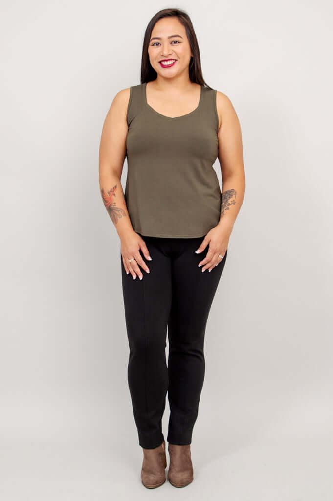 Model in olive bamboo tank top and black pants, facing forward