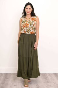 Model wearing an olive green tiered maxi skirt with a floral sleeveless blouse