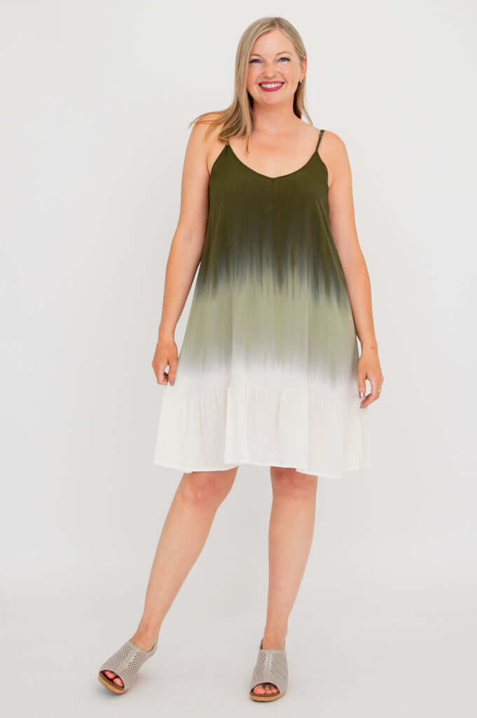 Woman modeling olive ombre mini dress, standing with legs apart, front view