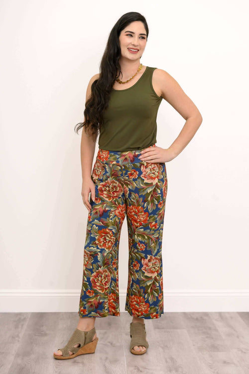 Model wearing olive tank and wide leg pants with bold red floral print