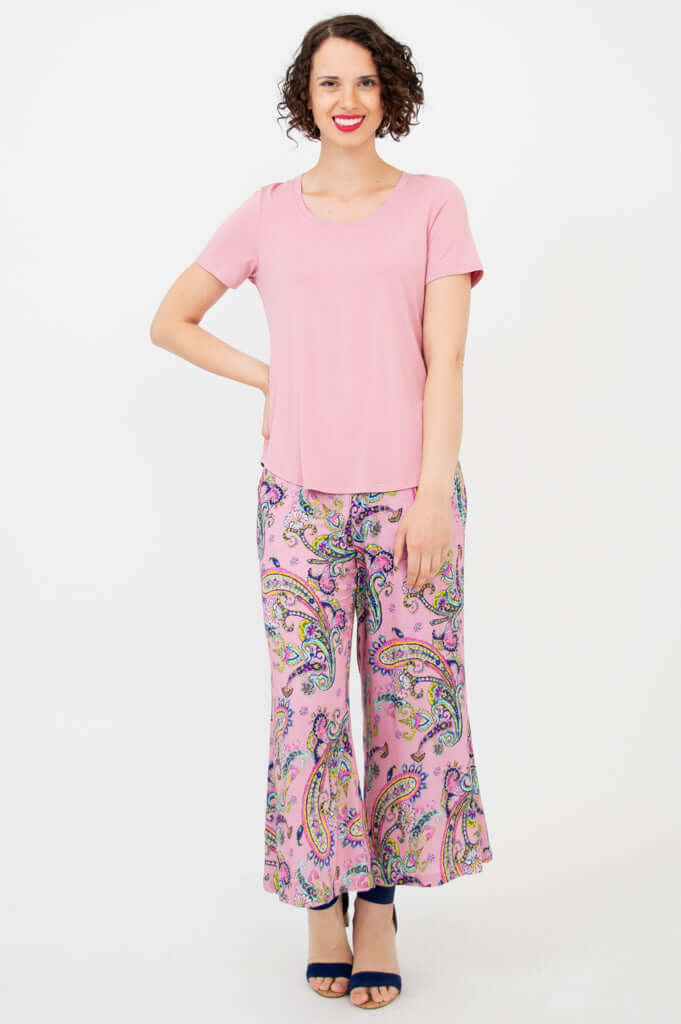 Front view of smiling model in Tessa Tee and paisley print pants