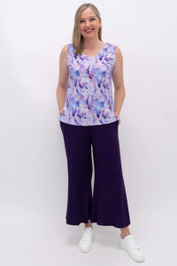 Model wearing a purple watercolor tank top with wide leg purple pants and sneakers
