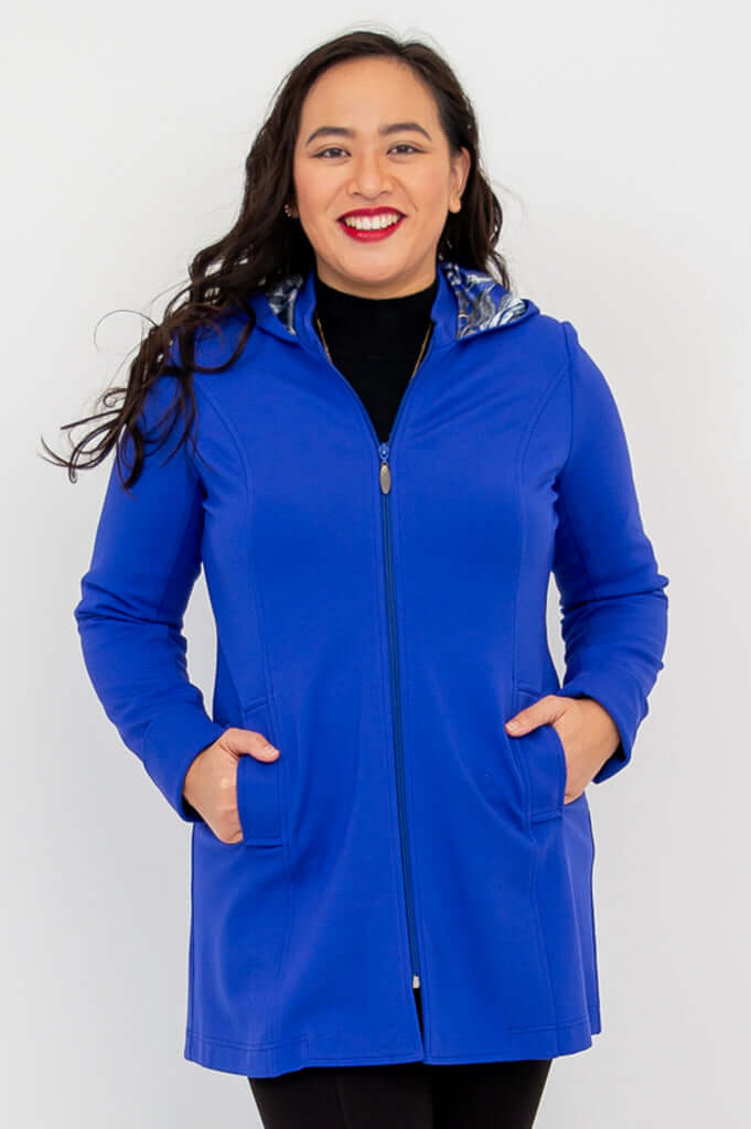 Front view of model wearing royal blue zip-up Highlands Coat with hood