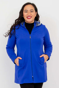 Front view of model wearing royal blue zip-up Highlands Coat with hood