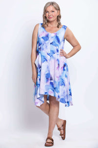 Woman posing in sleeveless watercolor dress with V-neck and pockets