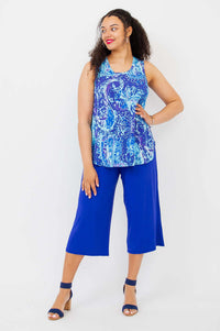 Woman posing in blue paisley bamboo tank top and blue culotte pants