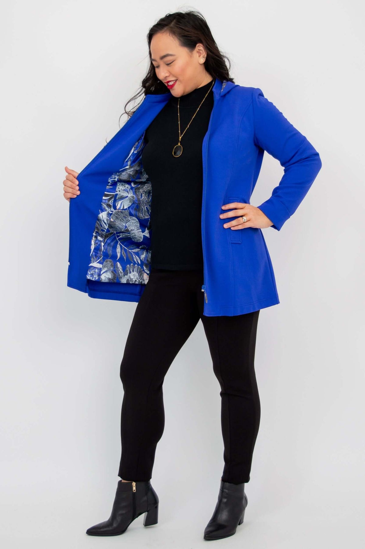 Side angle revealing floral interior lining of royal blue Highlands Coat