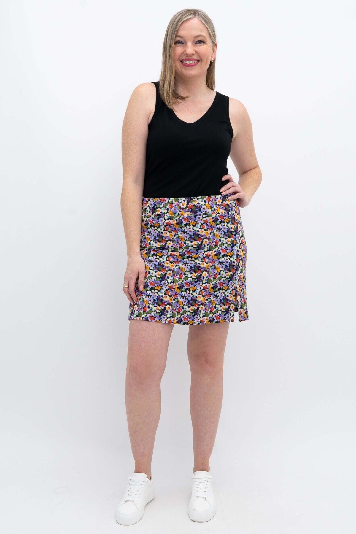 Woman modeling Melly Floral Skort with black tank top, smiling