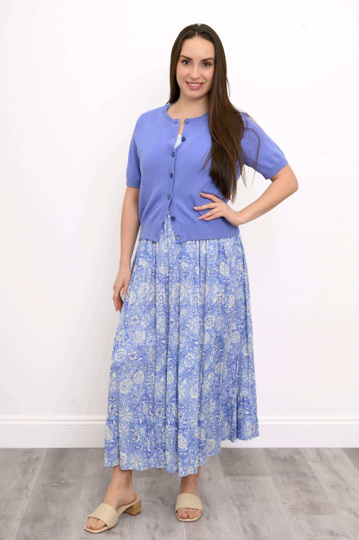 Woman modeling a blue floral tiered skirt with hand on hip