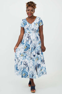 Model displaying the flowy skirt of the blue and white watercolor floral Morgan dress