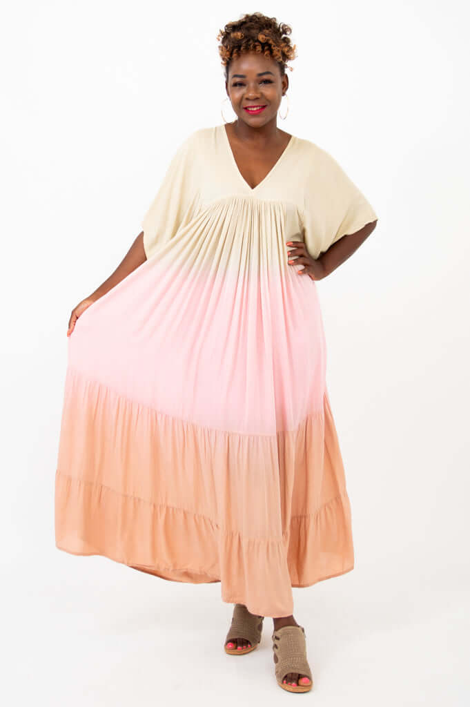 Model spreading skirt of flowing beige pink ombre maxi dress for shape