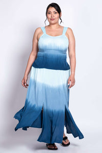 Model twirling in a blue ombre maxi dress with multiple slits