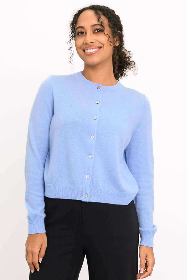 Model wearing a light blue cashmere cardigan with button-front closure