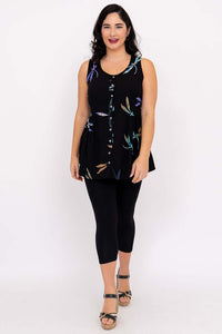 Woman modeling black batik tank top with colorful dragonfly pattern and shell buttons