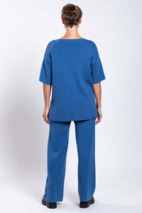 Back view of model wearing blue Bailey Pant and top
