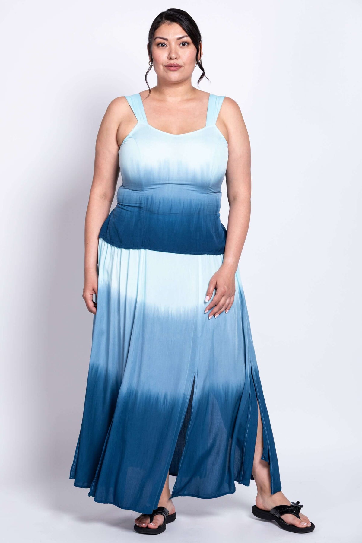 Woman in blue ombre maxi dress with flowy skirt and wide straps