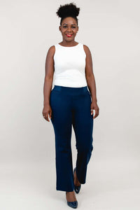 Model wearing indigo flare modal pants with a white tank top