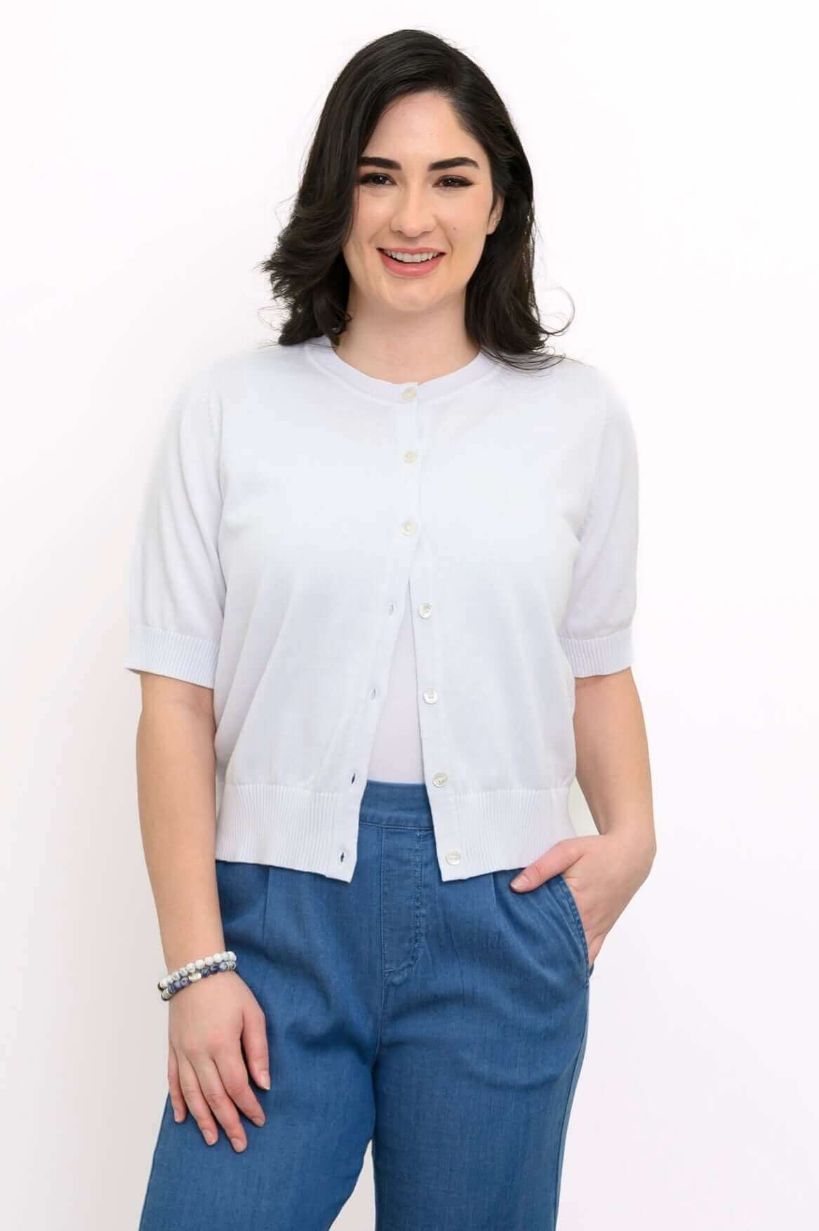 Model wearing a light short-sleeve button-up cardigan with blue pants