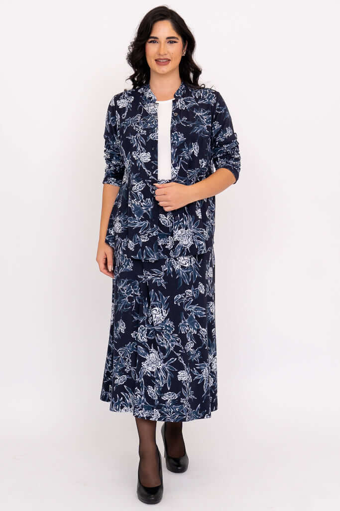 Model wearing matching navy floral skirt and jacket set