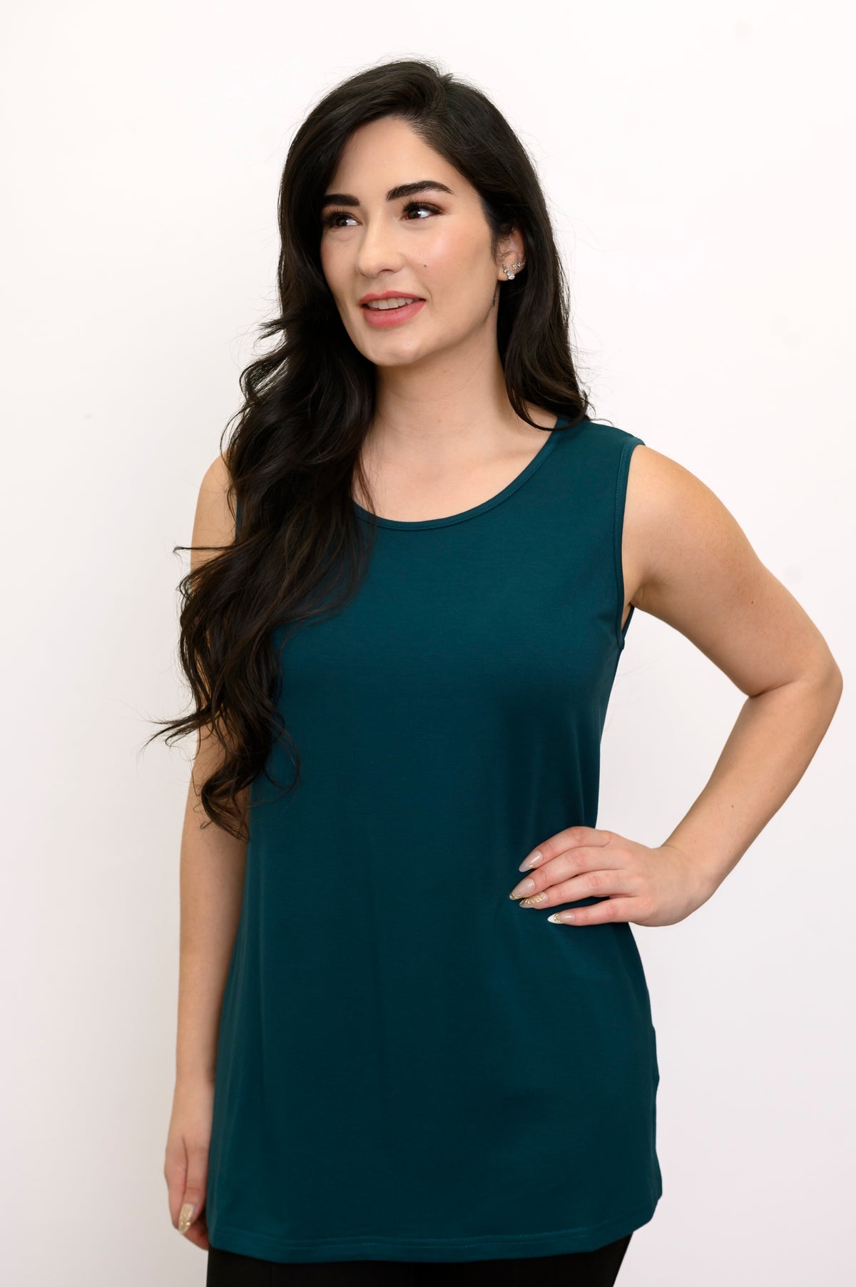 Straight-on portrait of a women's elegant crystal teal sleeveless knit layering tank top.