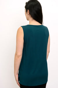 Rear studio shot of a loose-fit teal sleeveless top with a clean straight hemline, styled over black trousers.