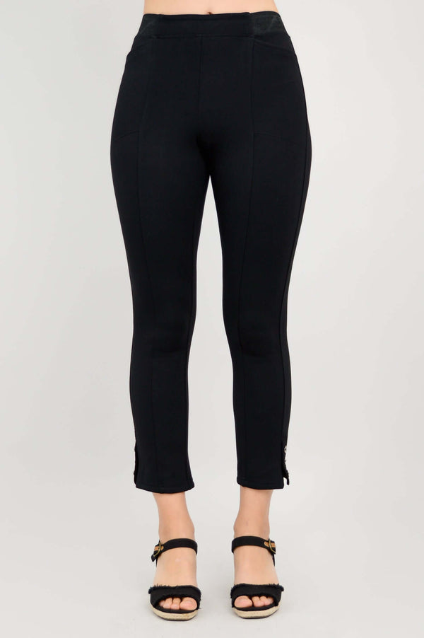 Front view of the Nadine Crop Pant in black, featuring a slim fit and button detail at the hem