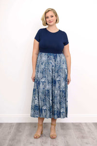 Woman wearing a navy blue and blue floral print empire waist maxi dress