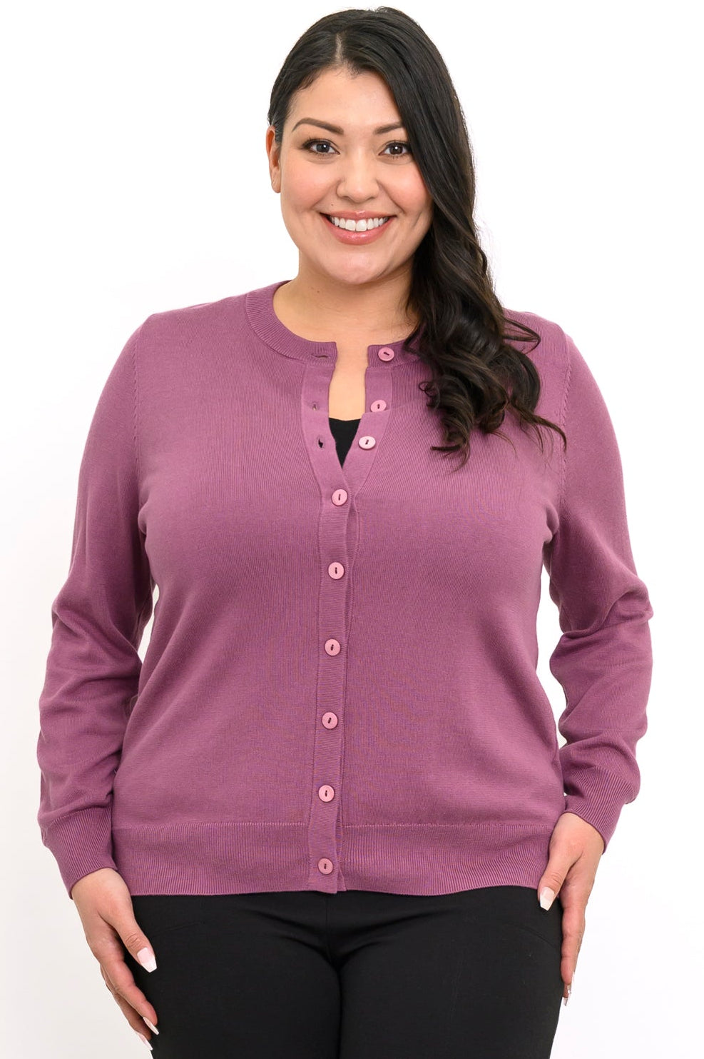 Close up front view of a woman wearing a vintage pink crewneck button up cotton blend cardigan.