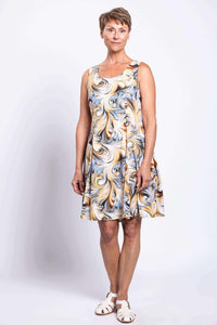 Older woman modeling a sleeveless swirl print dress with pockets