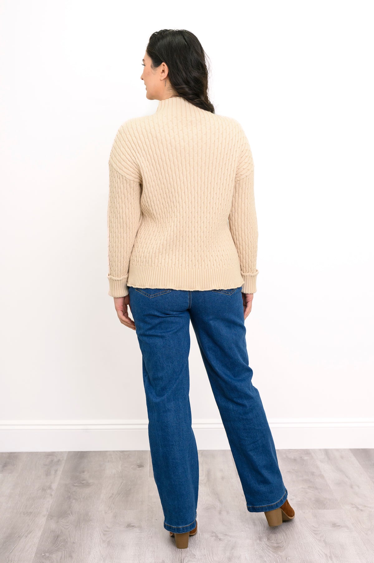 Rear view of a cream mock neck cotton pullover, highlighting its comfortable, mid-hip length classic fit.