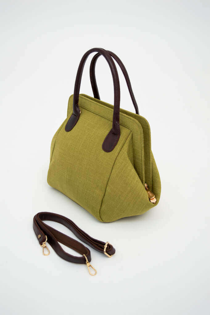 Olive green handbag with dark brown handles and removable strap displayed on a white background