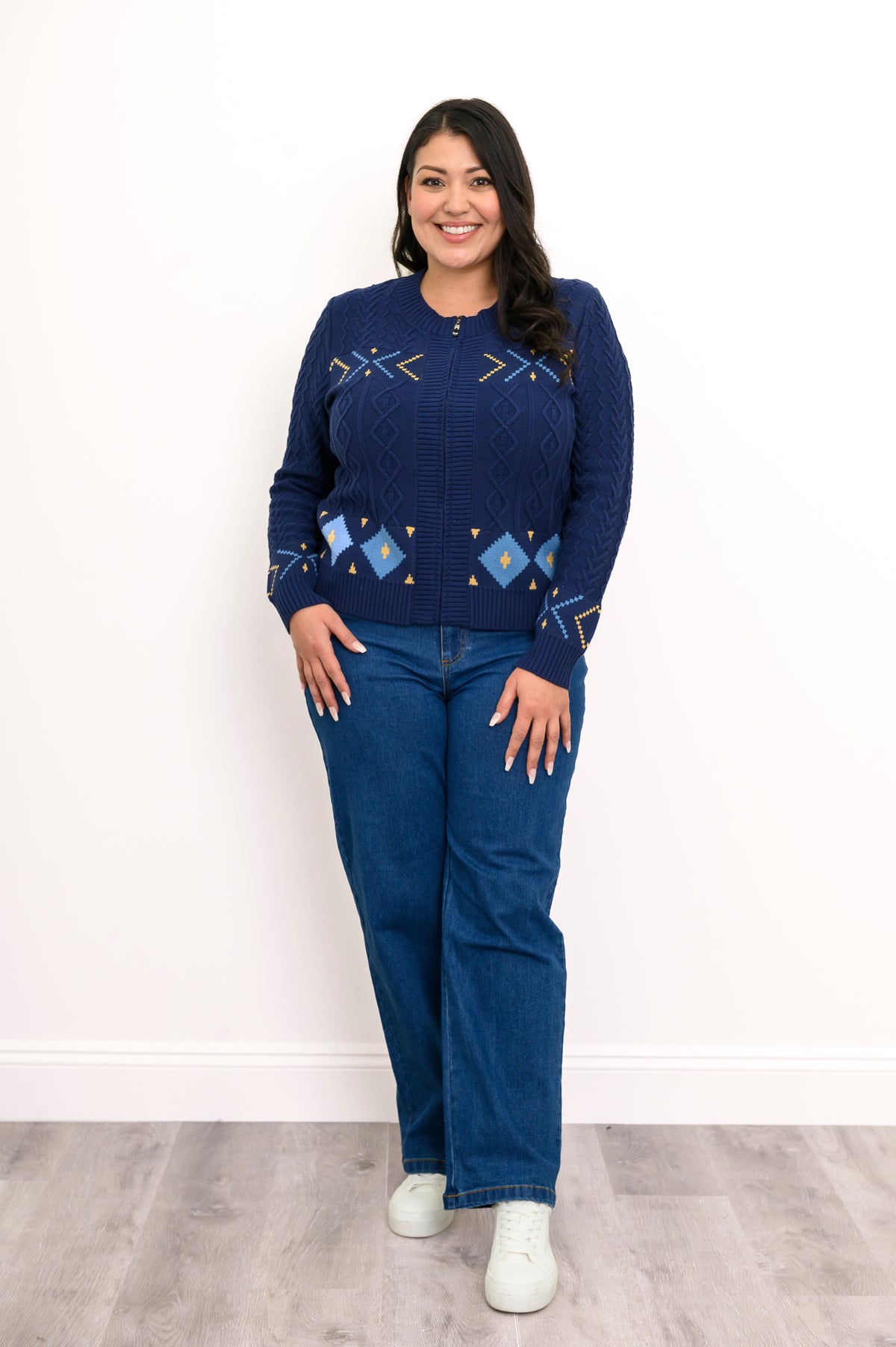 Classic horizontal geometric pattern navy top featuring ribbed cuffs and hem, styled casually with blue jeans.