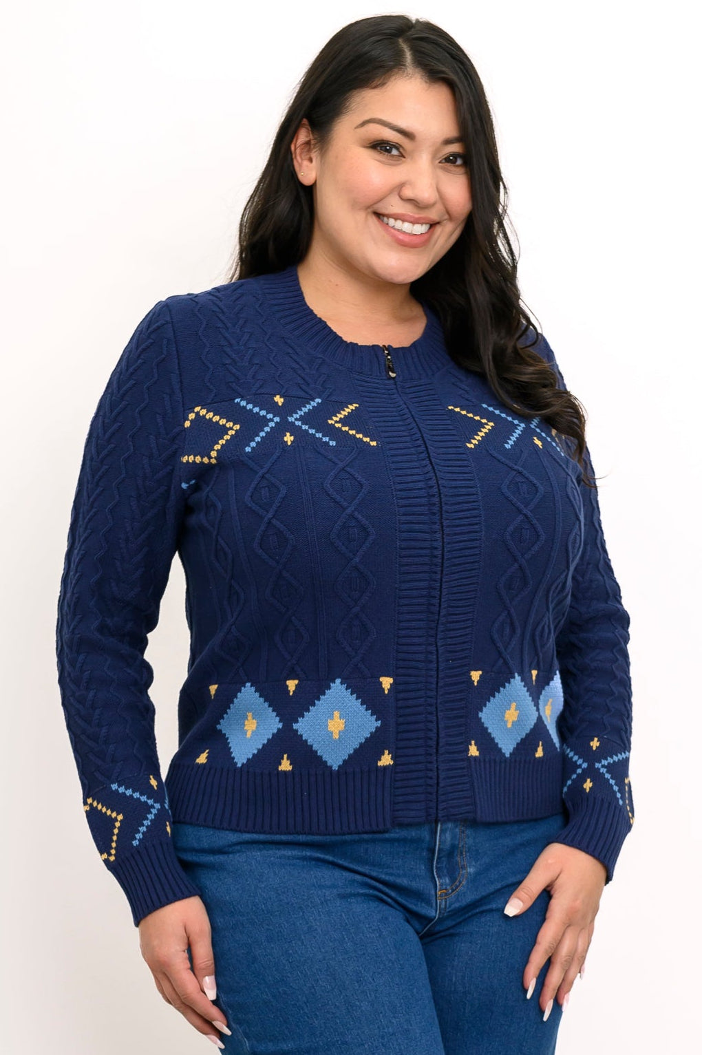 Smiling woman wearing an indigo knit sweater with a retro zip-up mock collar and colorful geometric patterns.