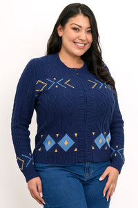Smiling woman wearing an indigo knit sweater with a retro zip-up mock collar and colorful geometric patterns.