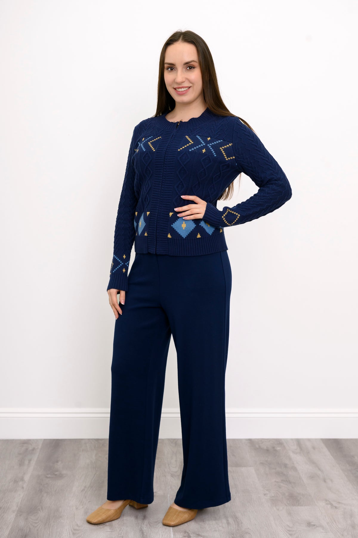 Front view of a women's cozy blue mock neck sweater, highlighting a comfortable, body-skimming drape on a model.