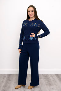 Front view of a women's cozy blue mock neck sweater, highlighting a comfortable, body-skimming drape on a model.